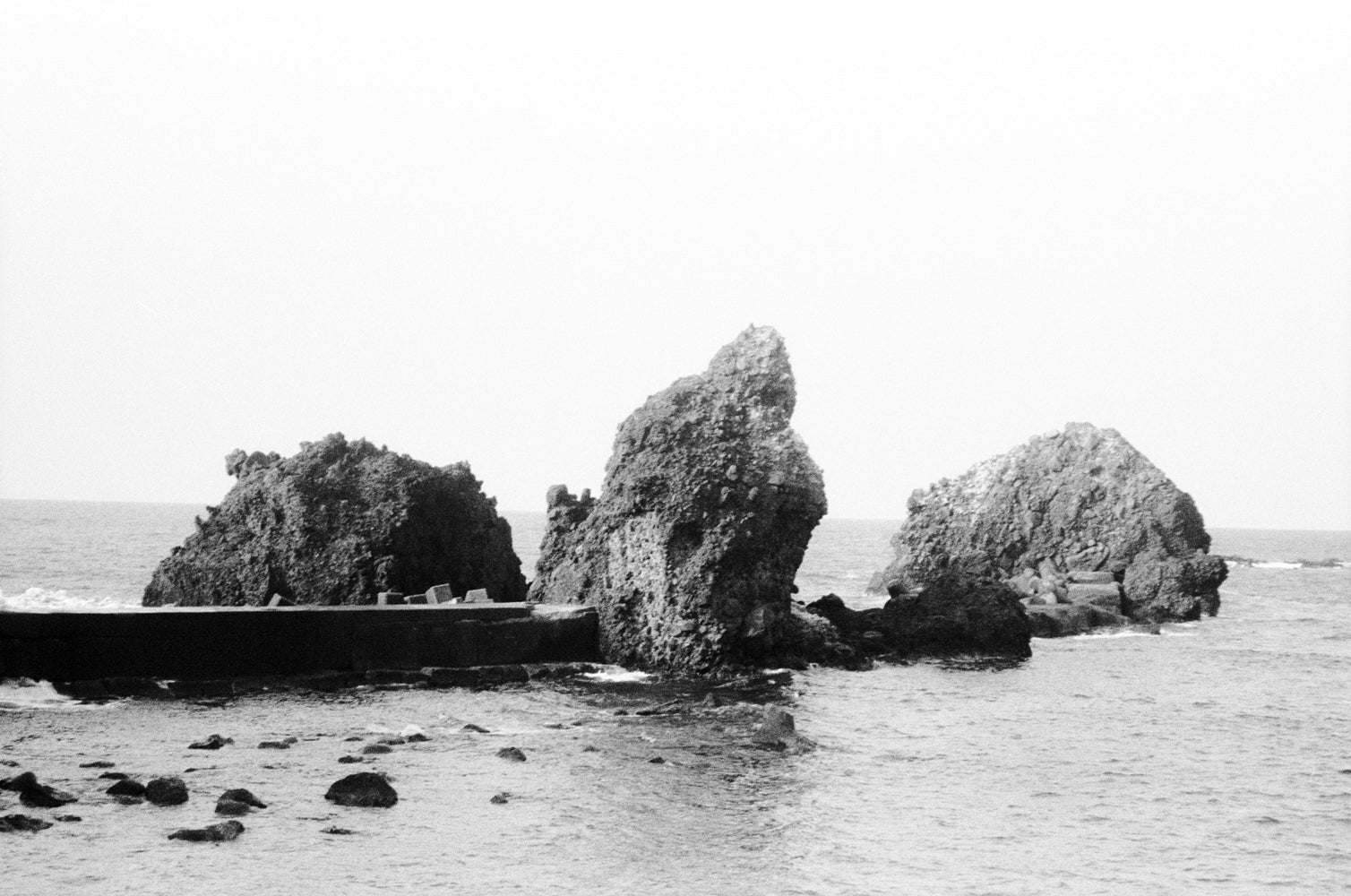 Black and white photo of rocky outcrops in the ocean