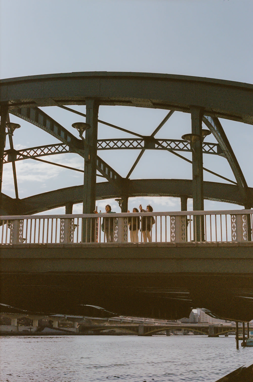 People standing on a bridge with a snowy landscape below