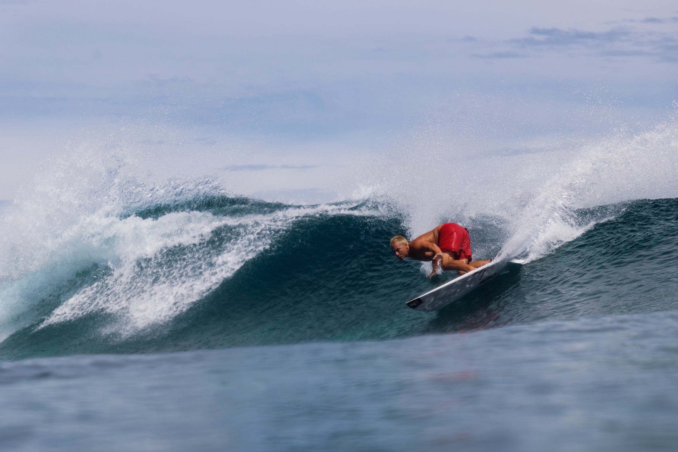 Person surfing on a wave in the ocean