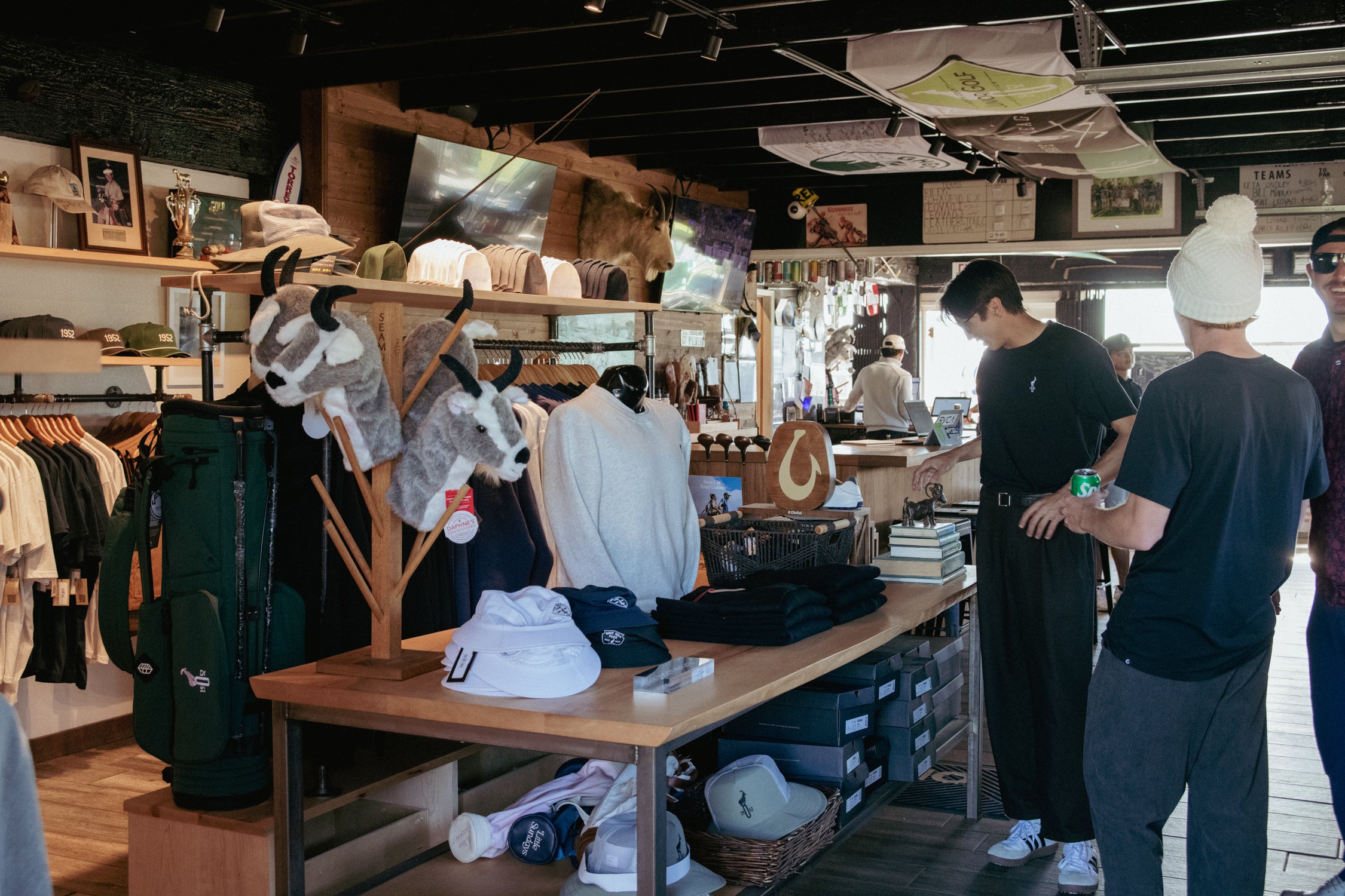 People shopping in a store with clothing and accessories displayed.