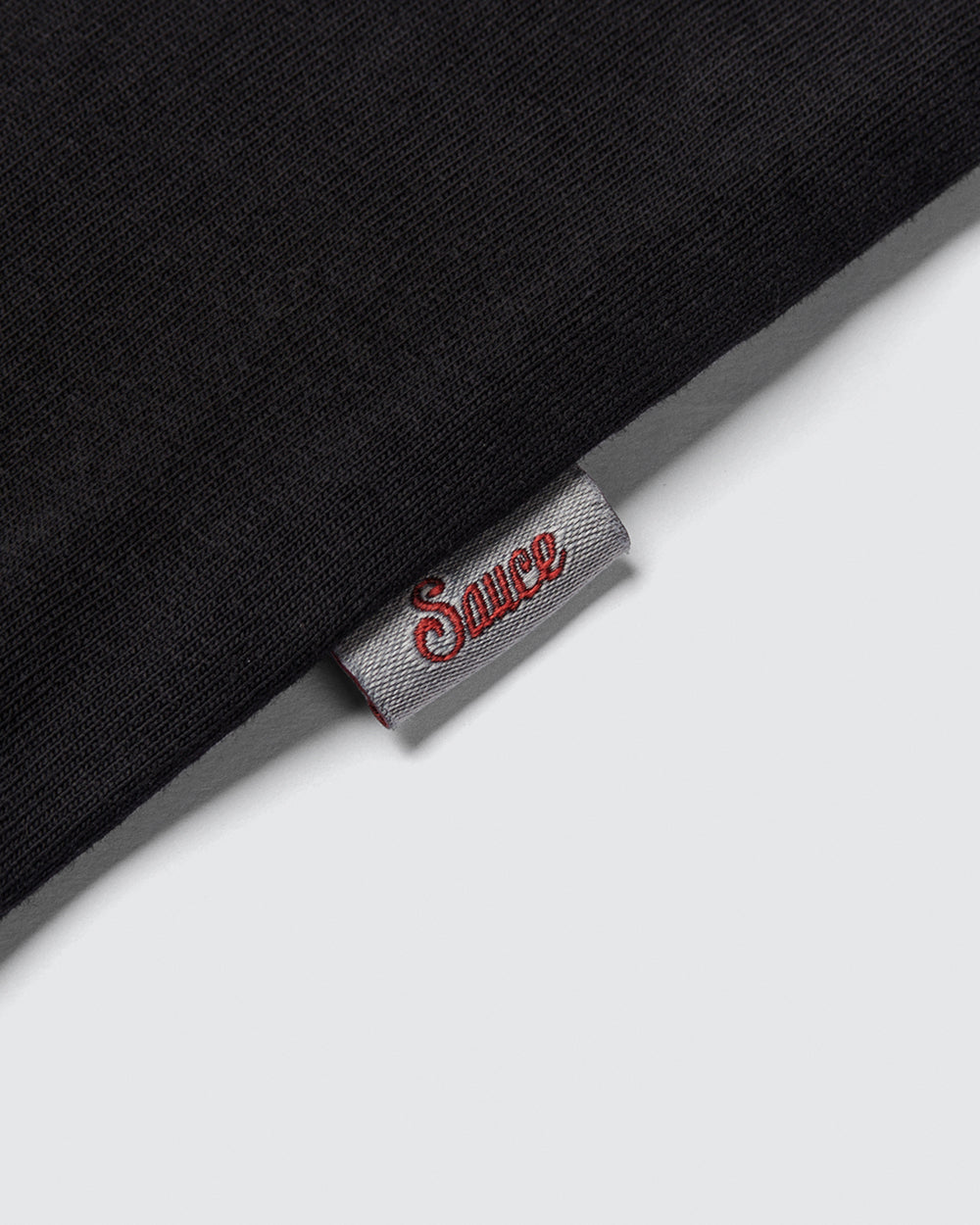 Close up of a label on the side of a black t-shirt