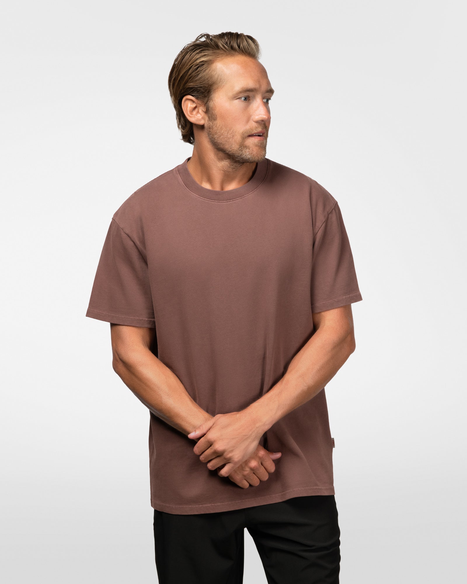 Man wearing a brown t-shirt against a white background