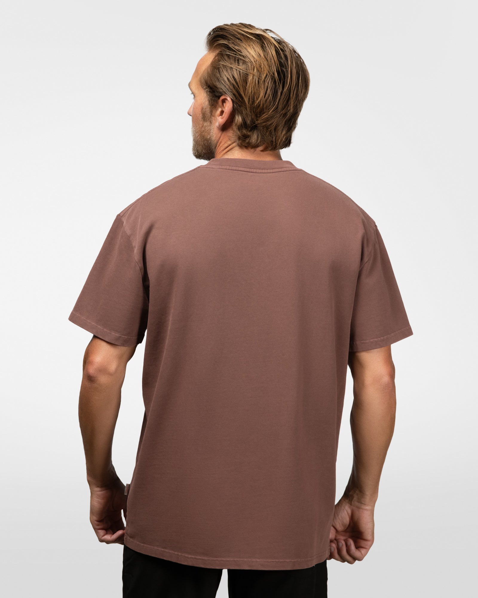 Man wearing a brown t-shirt on a white background