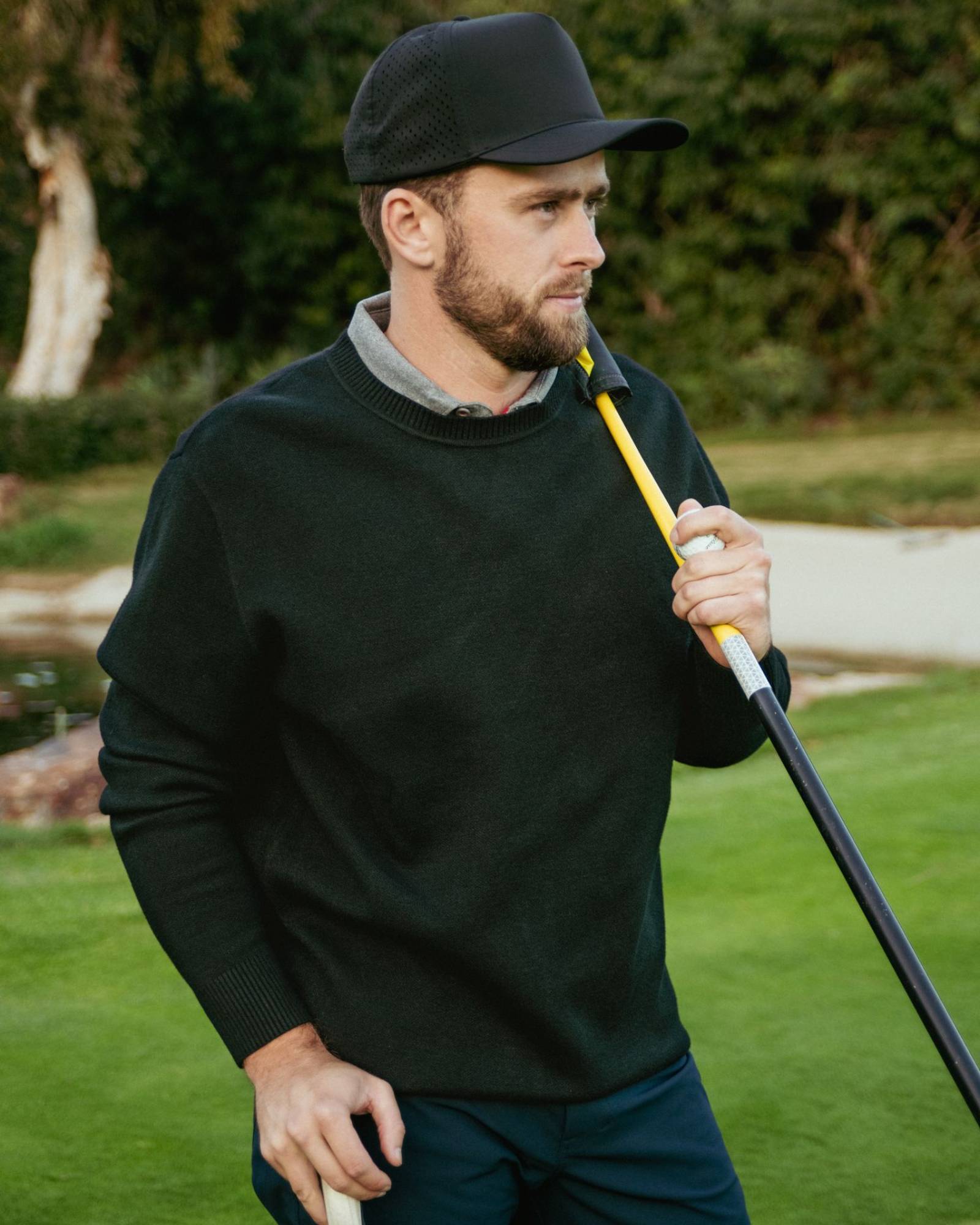 Man holding a golf club on a golf course